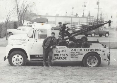Don Wiltse standing in front of tow truck
